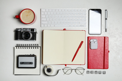 Flat lay composition with equipment for journalist on white table