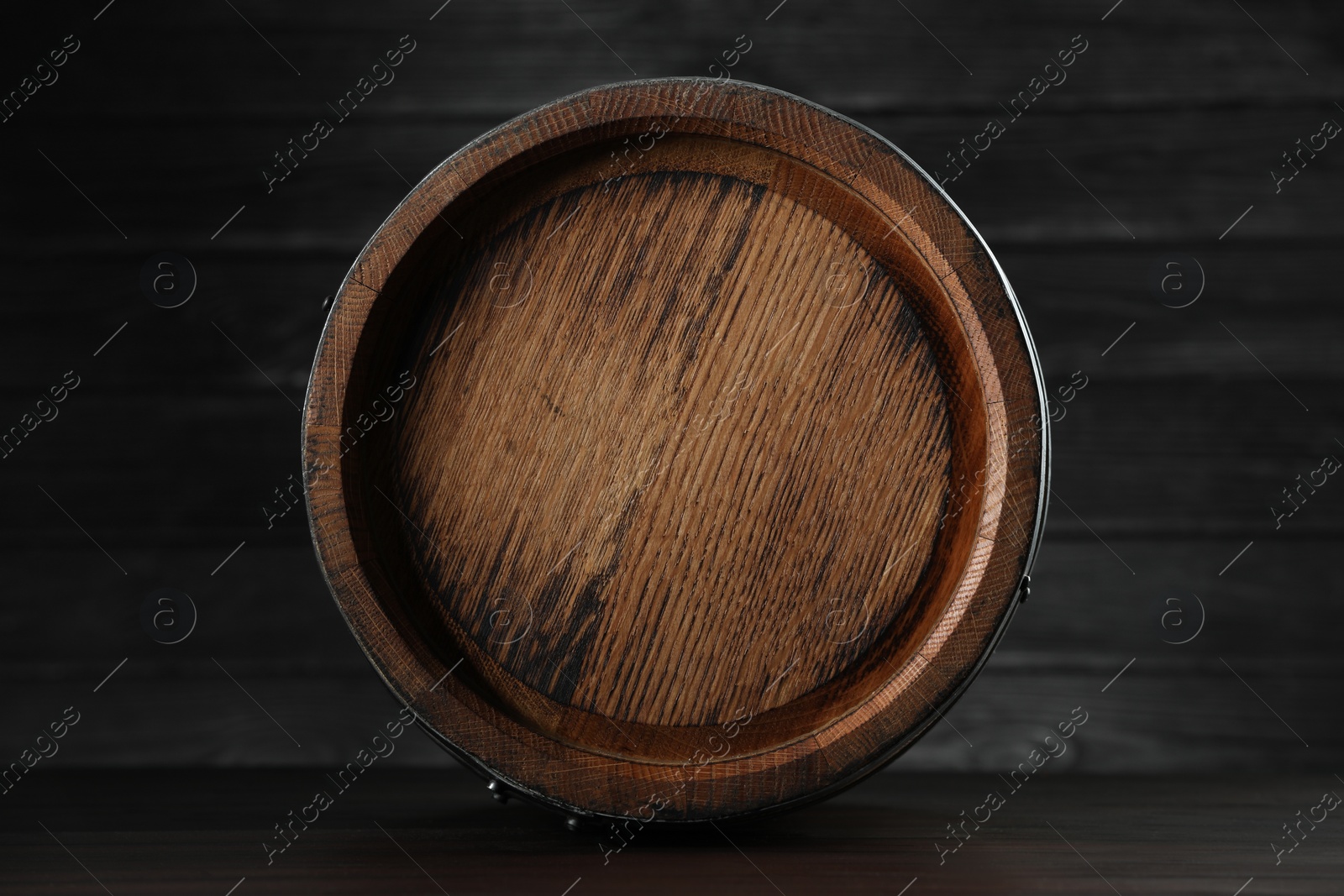 Photo of One wooden barrel near wall, closeup view