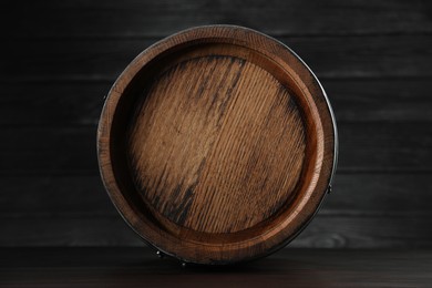 One wooden barrel near wall, closeup view