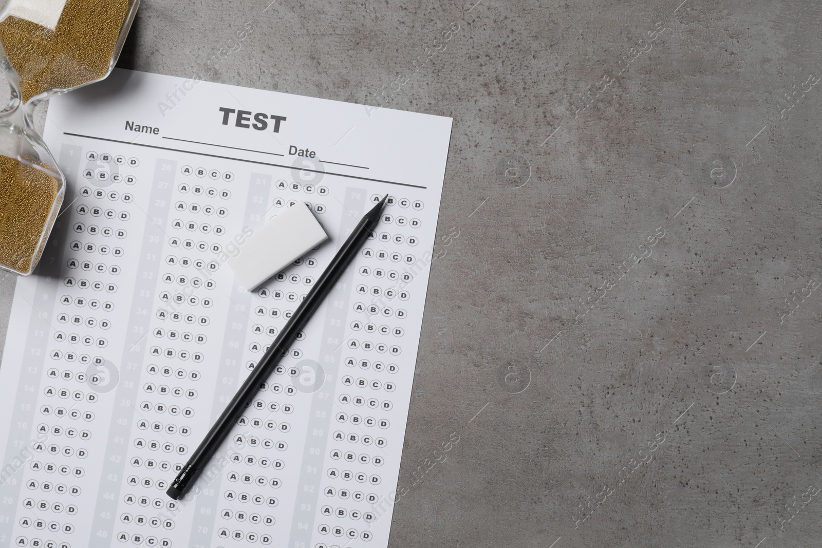 Photo of Flat lay composition with answer sheet and hourglass on light grey table, space for text. Student passing exam