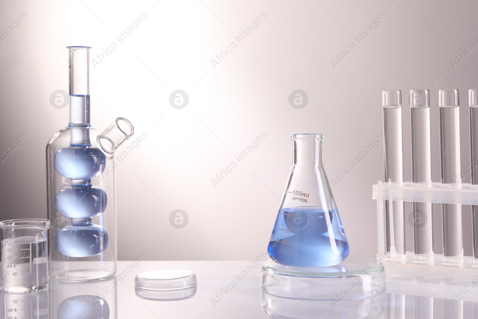 Photo of Laboratory analysis. Different glassware on table against light background