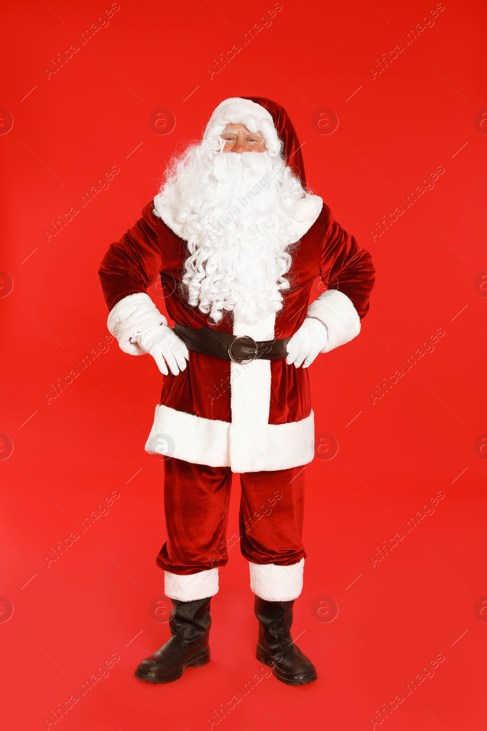 Photo of Happy authentic Santa Claus on red background