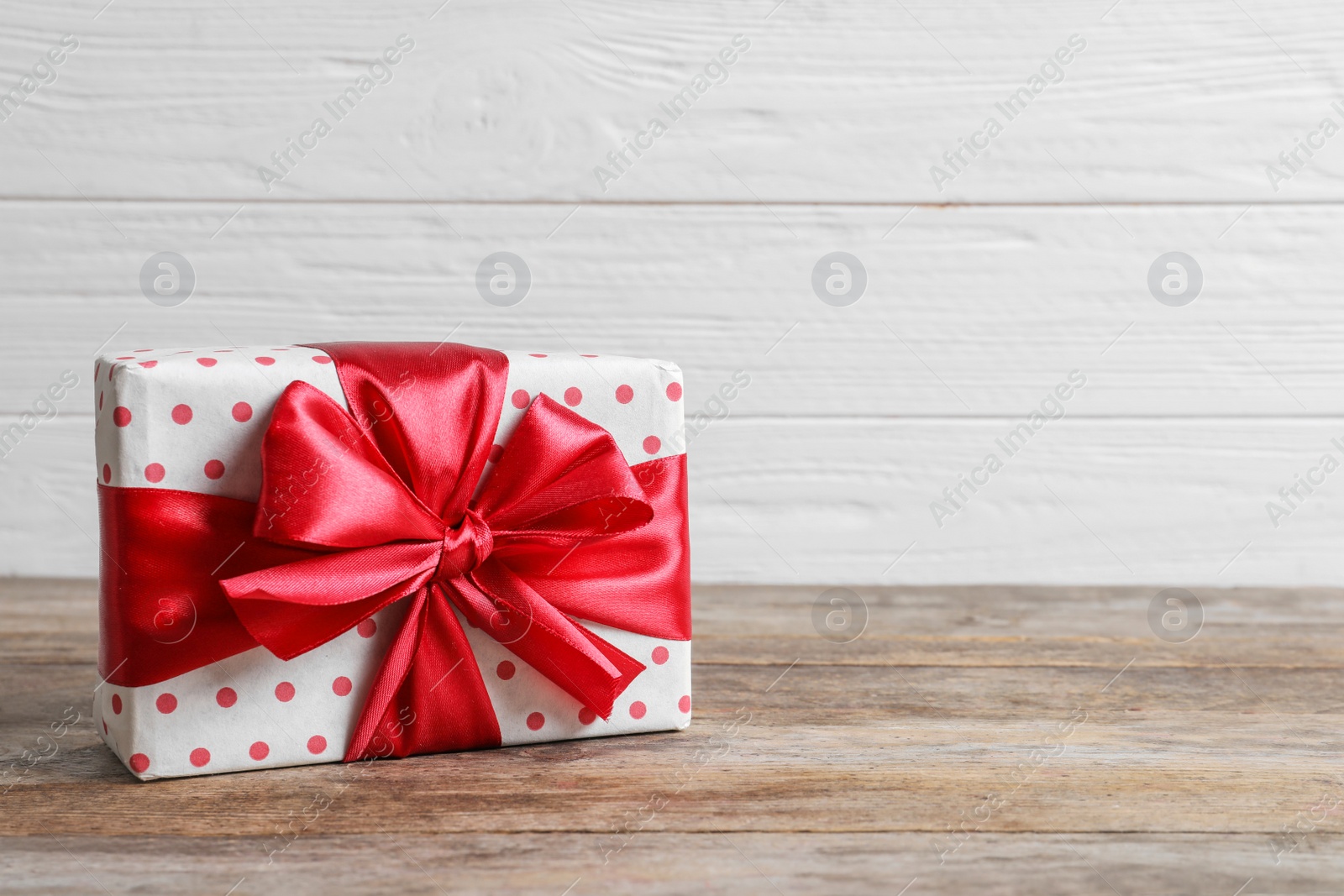 Photo of Beautiful gift box on wooden table