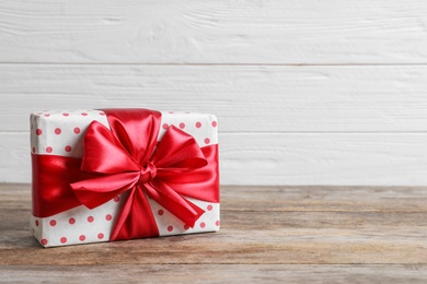 Beautiful gift box on wooden table