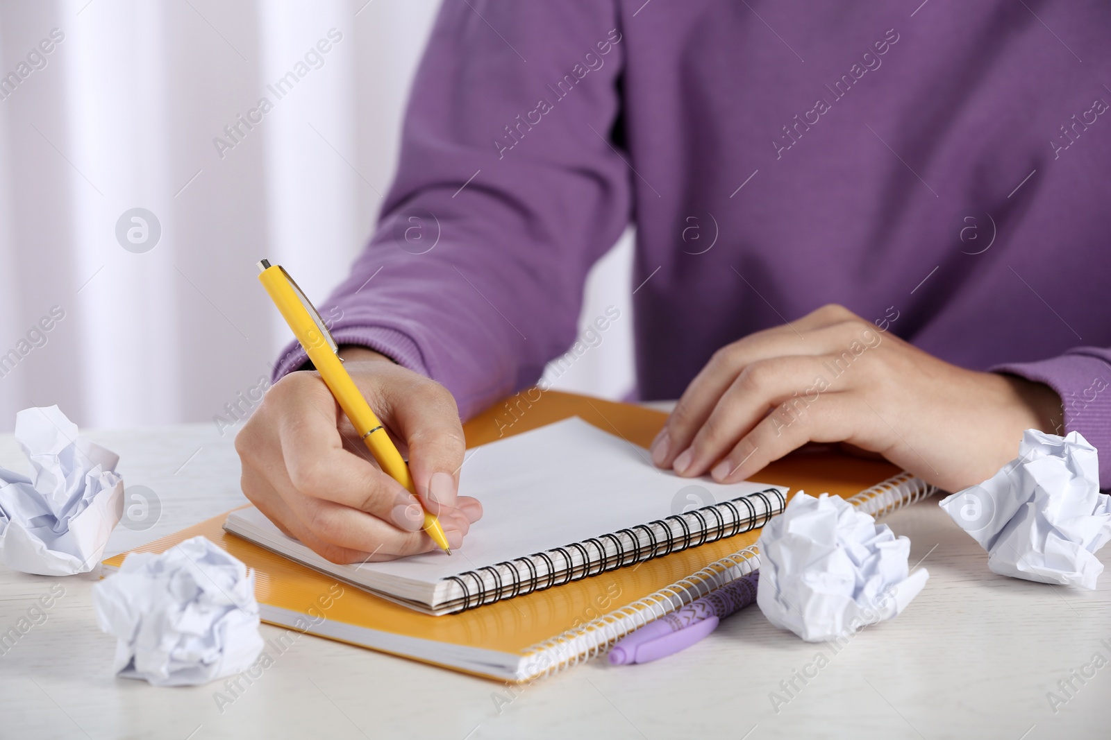 Photo of Woman working at table with crumpled paper, closeup. Generating idea