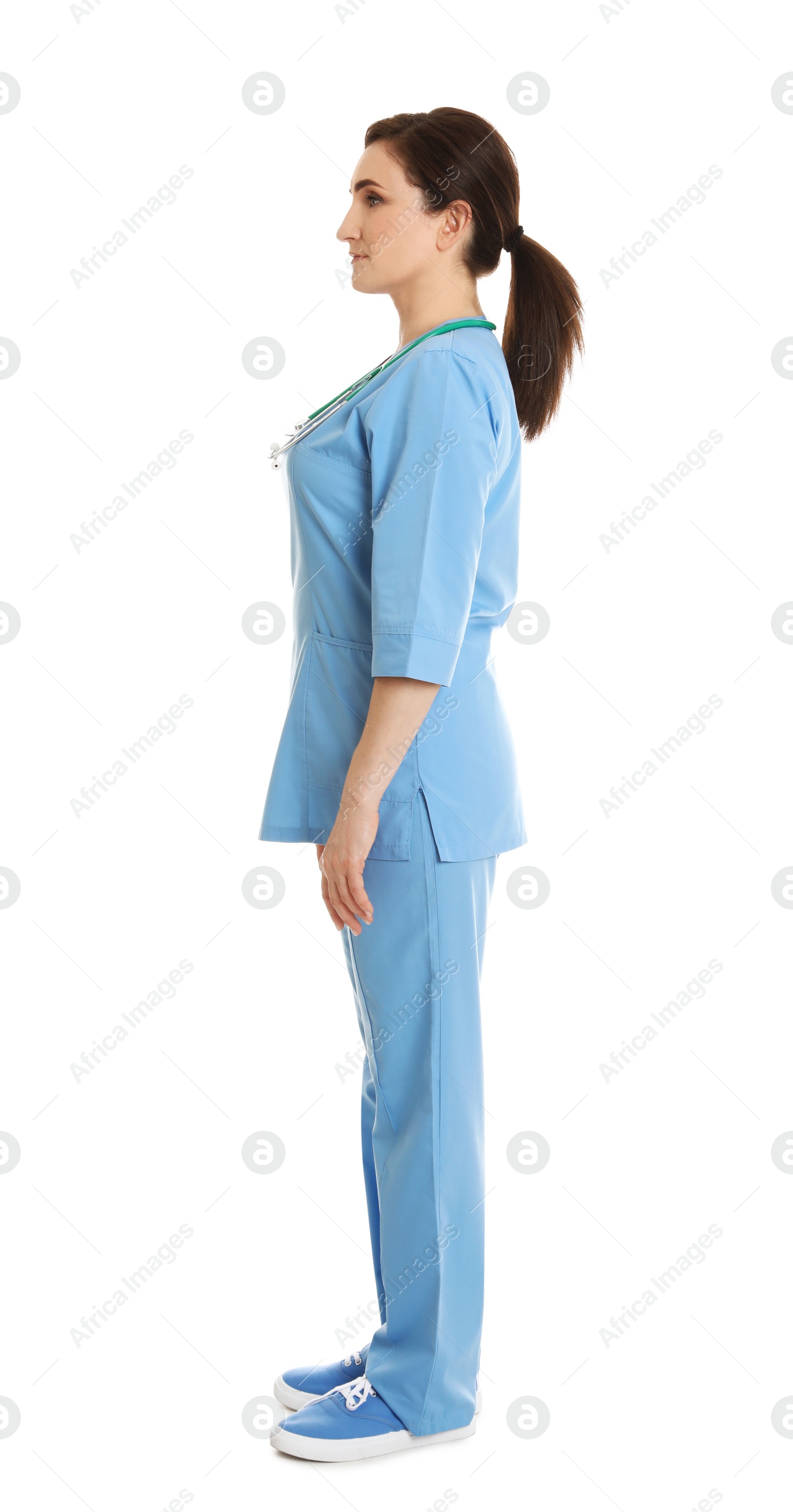 Photo of Full length portrait of female doctor in scrubs isolated on white. Medical staff