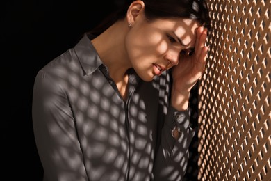 Photo of Upset woman listening to priest during confession in booth