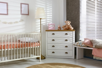 Cozy baby room interior with comfortable crib