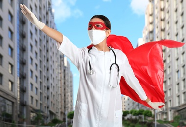 Image of Doctor dressed as superhero on city background. Medical workers fighting with dangerous diseases