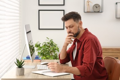 Photo of Man studying near computer at home. Online translation course