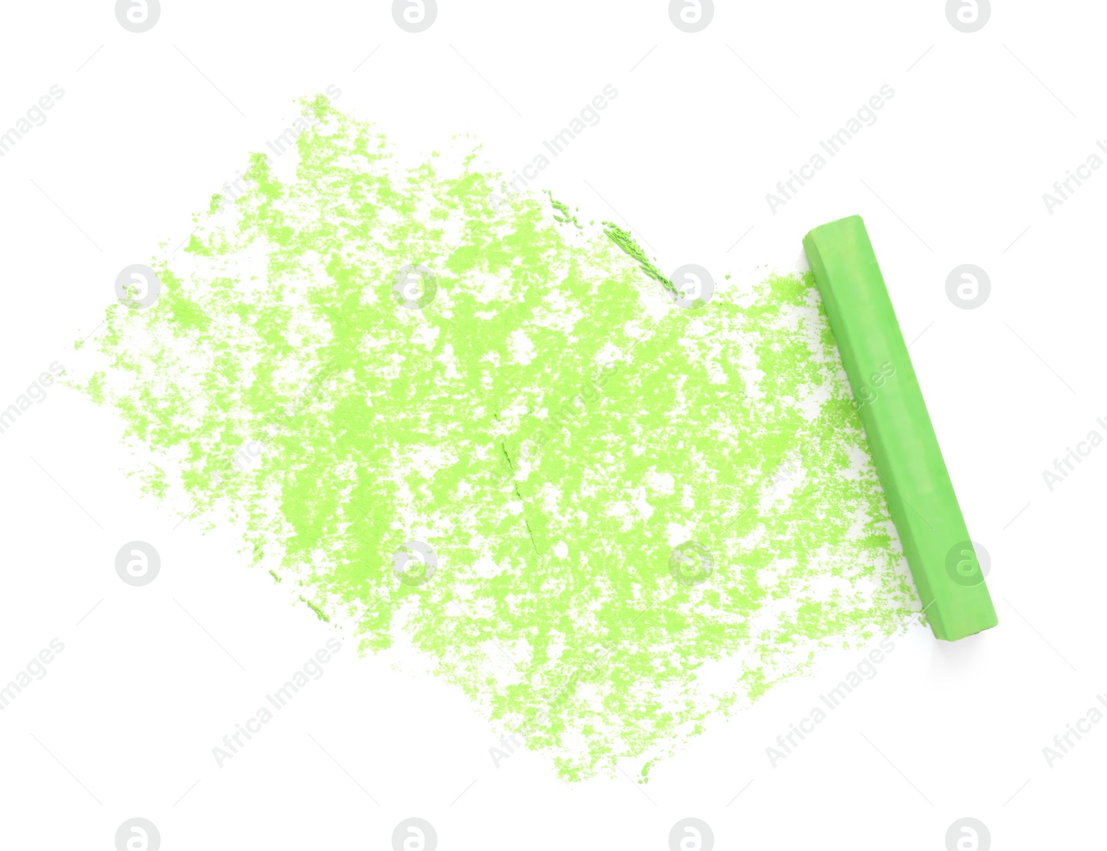 Photo of Green pastel chalk on sheet of paper with scribble, top view. Drawing material