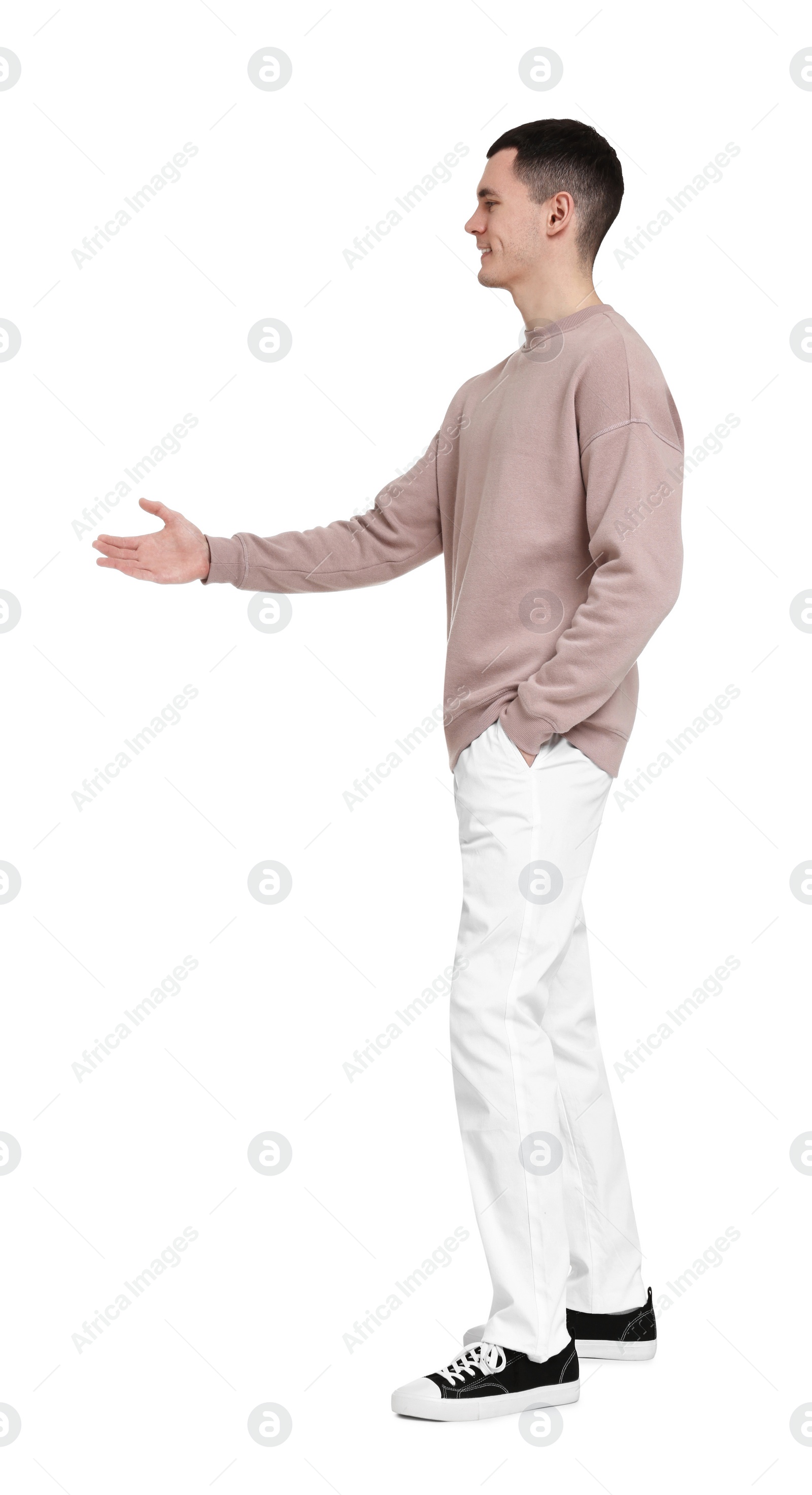 Photo of Handsome young man greeting someone on white background