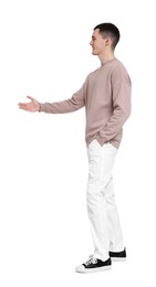 Handsome young man greeting someone on white background