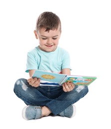 Photo of Cute little boy reading book on white background