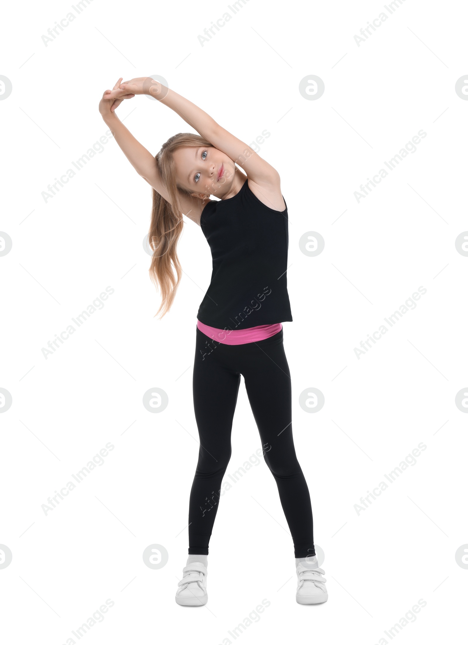 Photo of Little girl doing morning exercise on white background