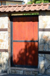 Wooden door with intercom outdoors. Private property