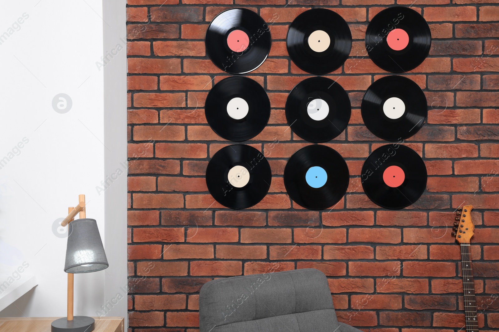 Photo of Vinyl records on brick wall in living room