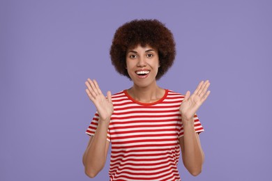 Portrait of emotional young woman on purple background