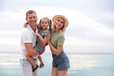 Happy family near sea on sunny summer day