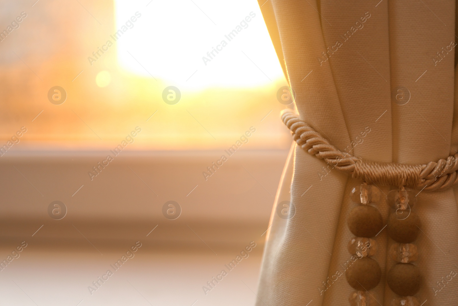 Photo of Window with beautiful beige curtain, closeup view