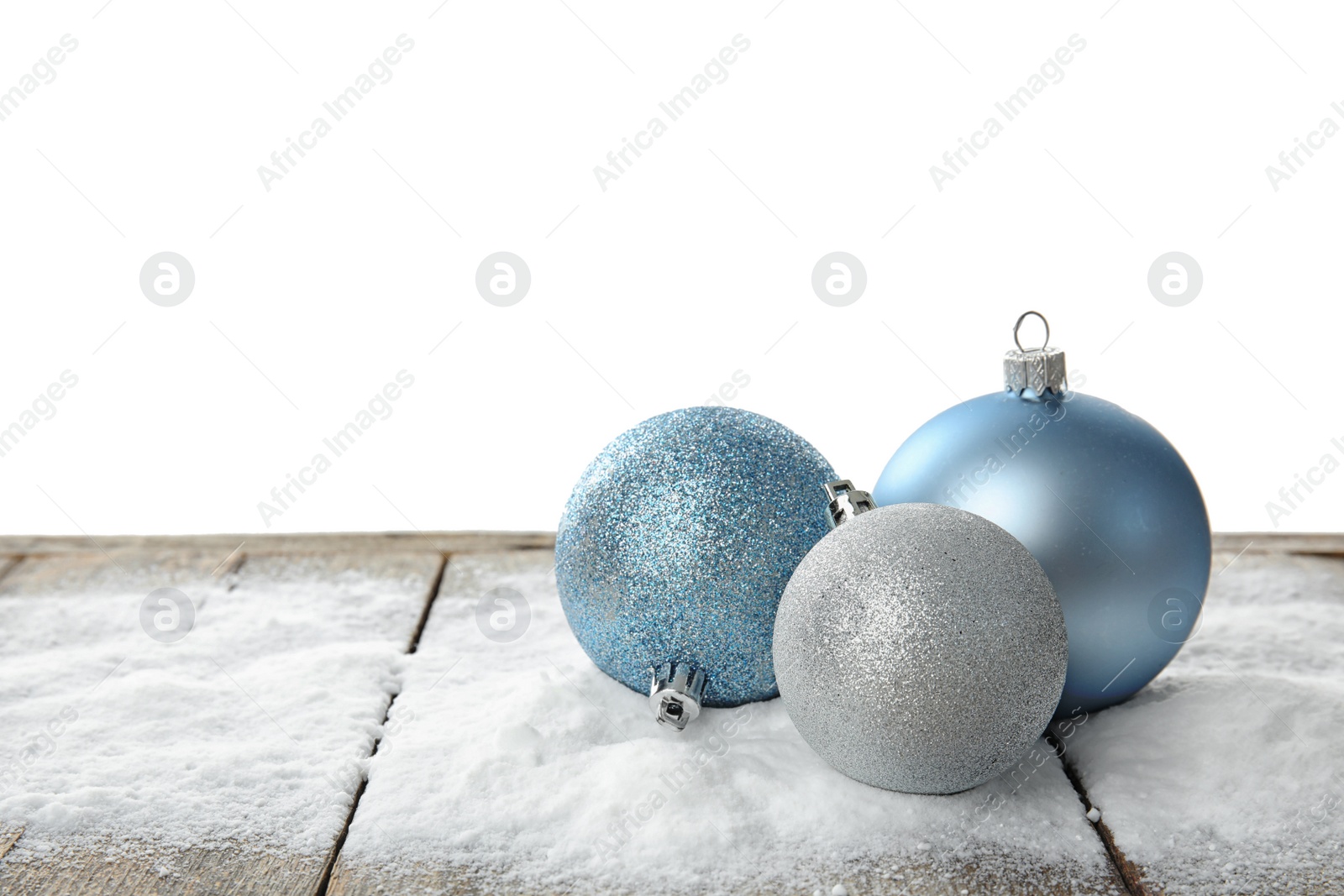 Photo of Christmas decoration and snow on table against white background