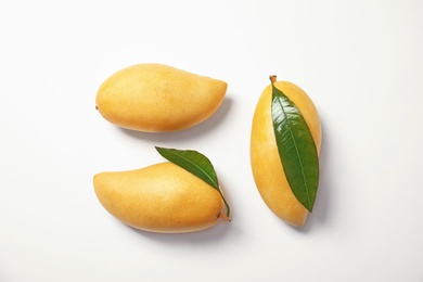 Composition with fresh mango fruits on white background, top view