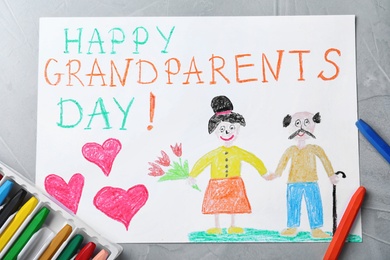 Photo of Beautiful drawing on grey table, flat lay. Happy Grandparents Day