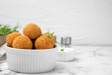 Photo of Bowl of delicious fried tofu balls with pea sprouts on white marble table, space for text