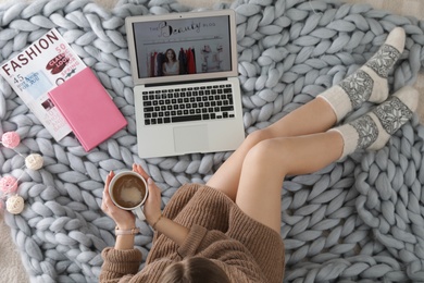 Photo of Woman and laptop with beauty blogger site on floor, top view