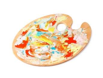 Photo of Wooden artist's palette with mixed paints isolated on white