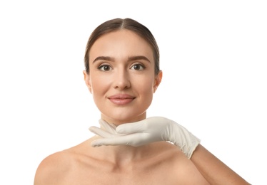 Doctor examining woman's face before plastic surgery on white background