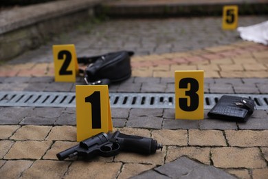 Photo of Crime scene markers and evidences outdoors, closeup