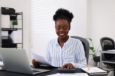 Photo of Professional accountant working at desk in office