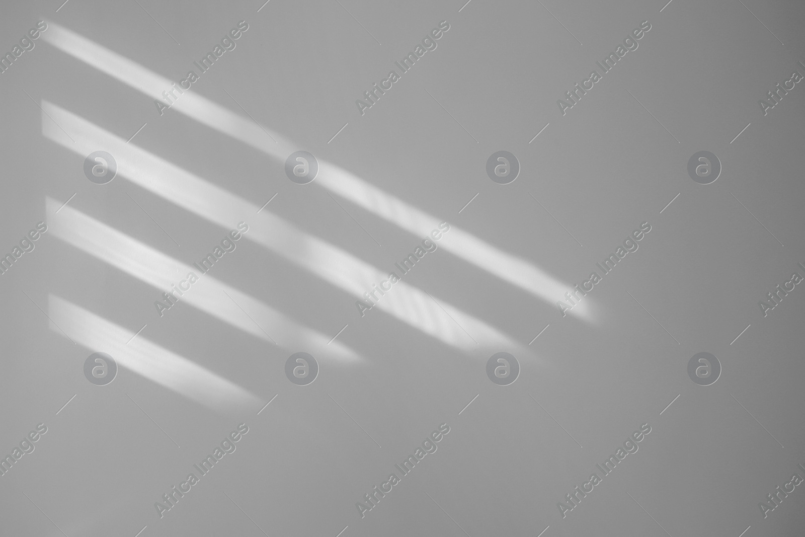 Image of Light and shadows falling on white wall