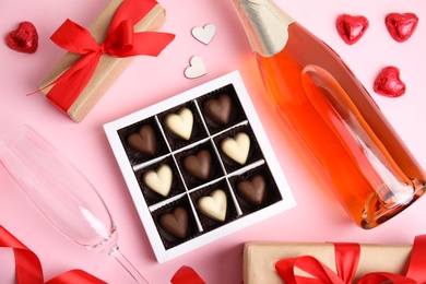Photo of Flat lay composition with heart shaped chocolate candies on pink background. Happy Valentine's day