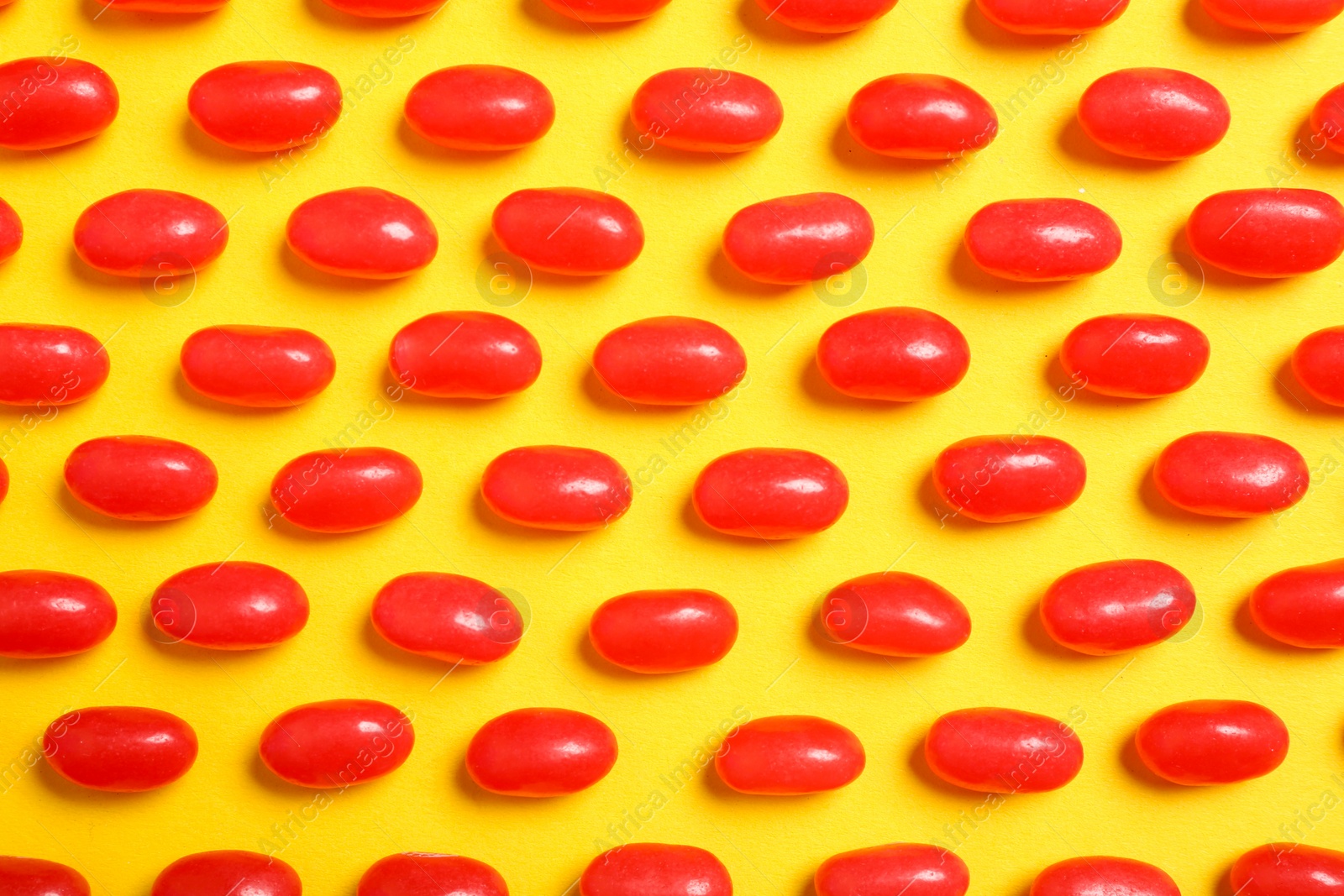 Photo of Flat lay composition with delicious jelly beans on color background