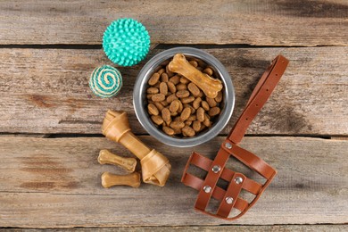 Different pet goods on wooden table, flat lay. Shop assortment