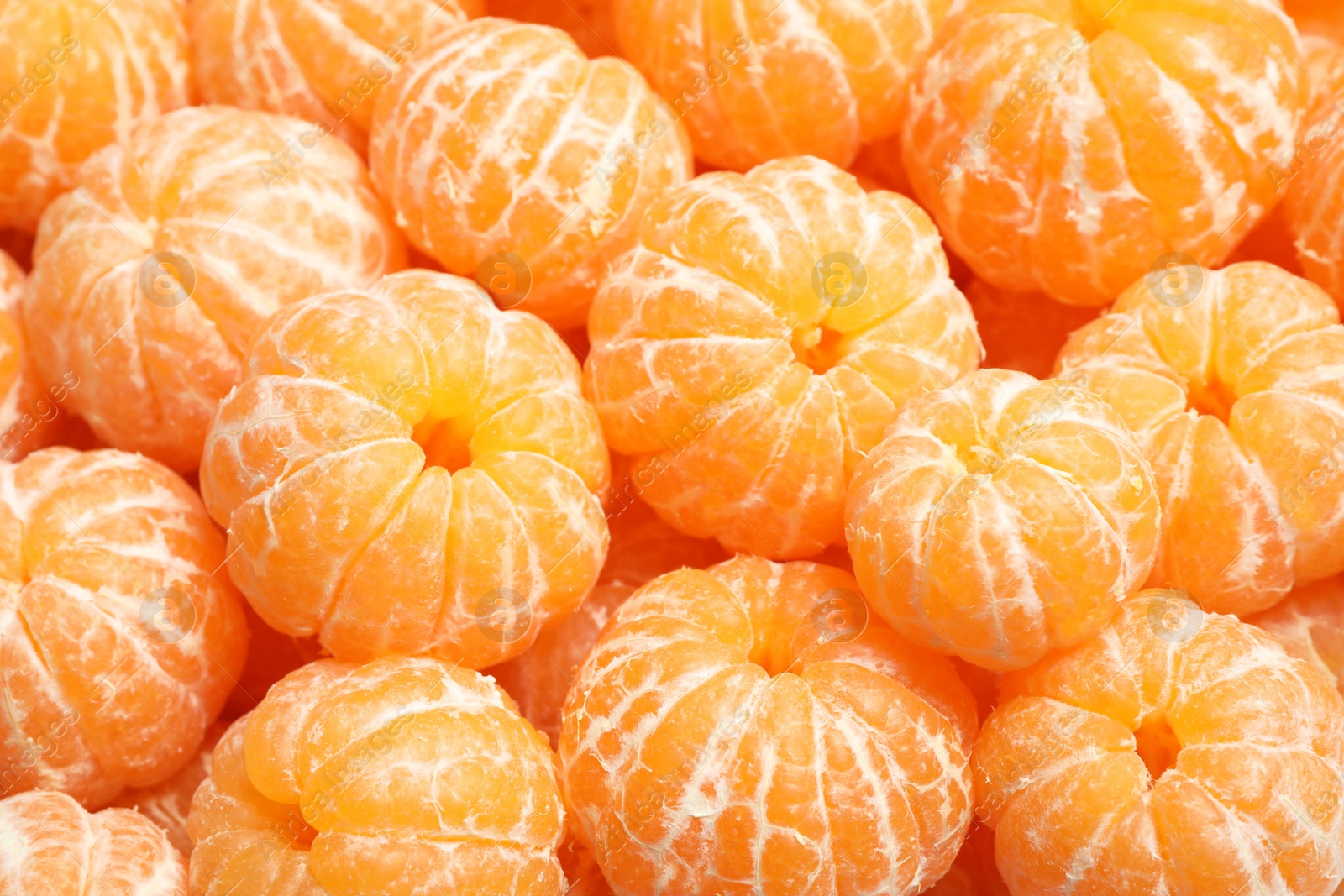 Photo of Peeled fresh ripe tangerines as background, closeup