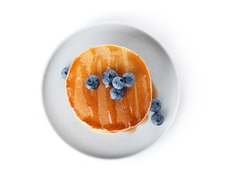 Photo of Stack of tasty pancakes with maple syrup and fresh berries on white background, top view