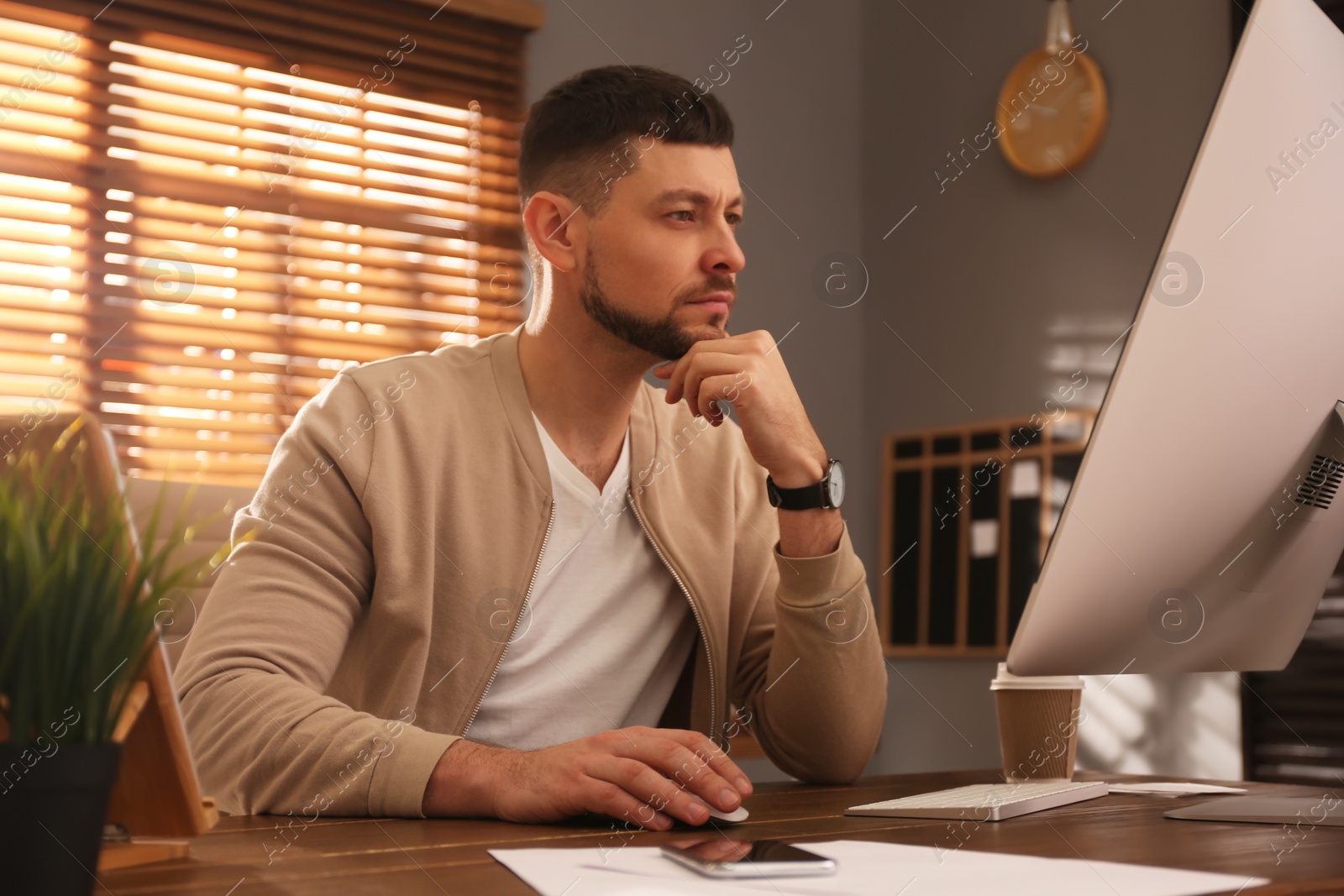 Photo of Freelancer working on computer at table indoors