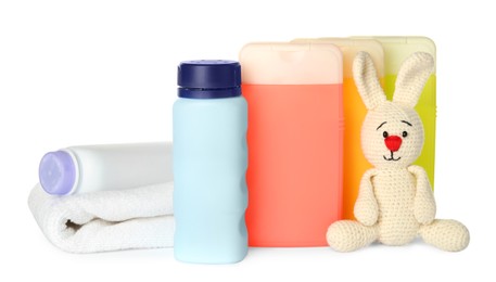 Photo of Set of baby cosmetic products, toy bunny and towel on white background