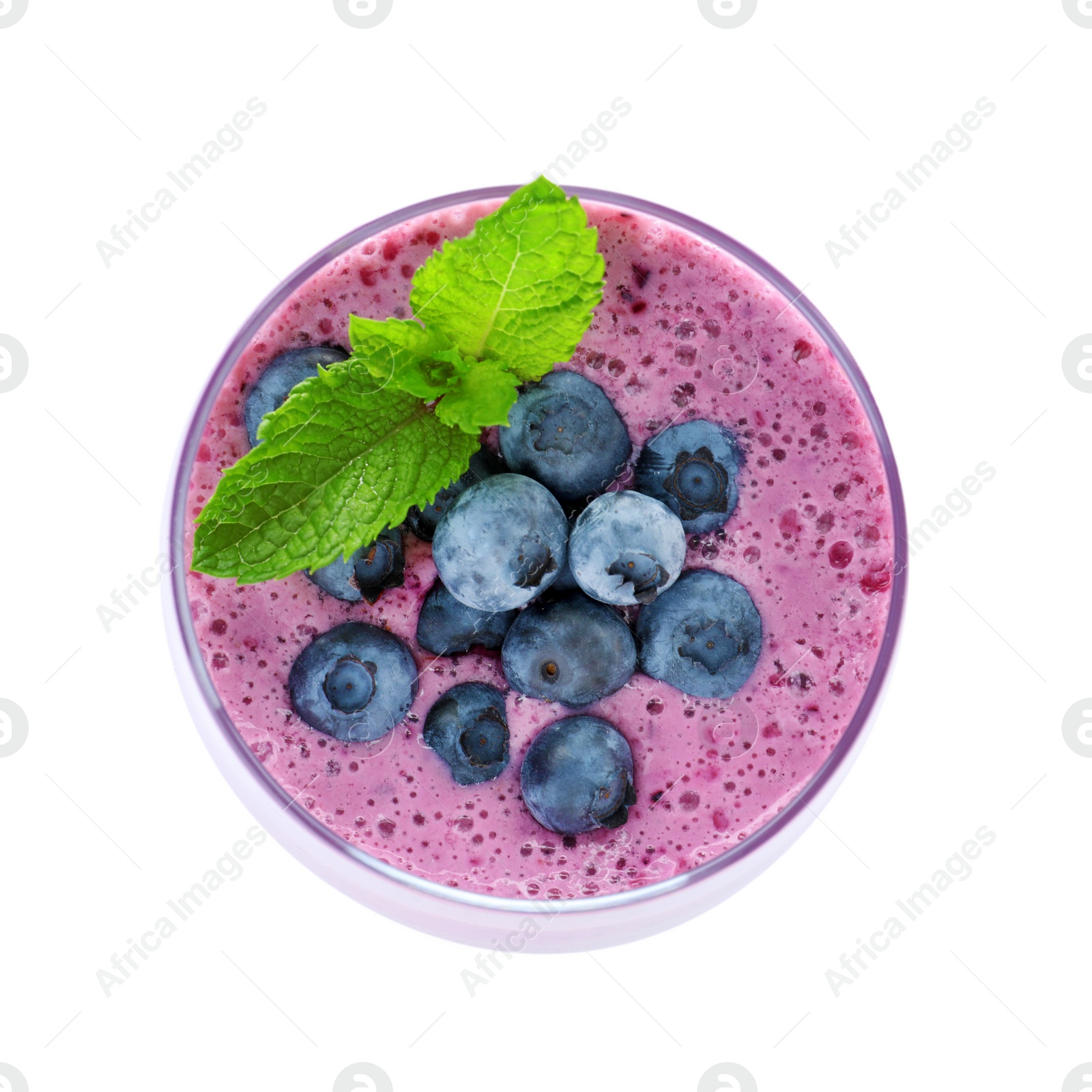 Photo of Glass of tasty blueberry smoothie with mint on white background, top view