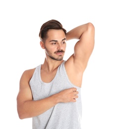 Photo of Handsome young man showing armpit on white background. Using deodorant