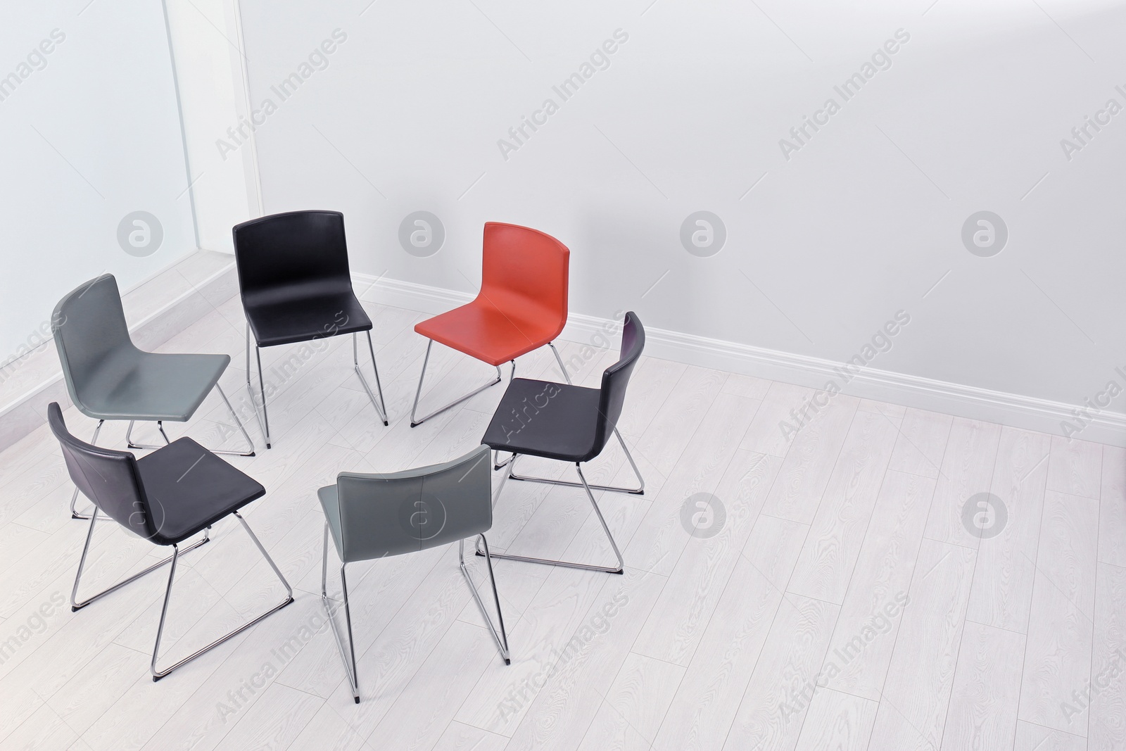 Photo of Chairs prepared for group therapy session in office, space for text. Meeting room interior