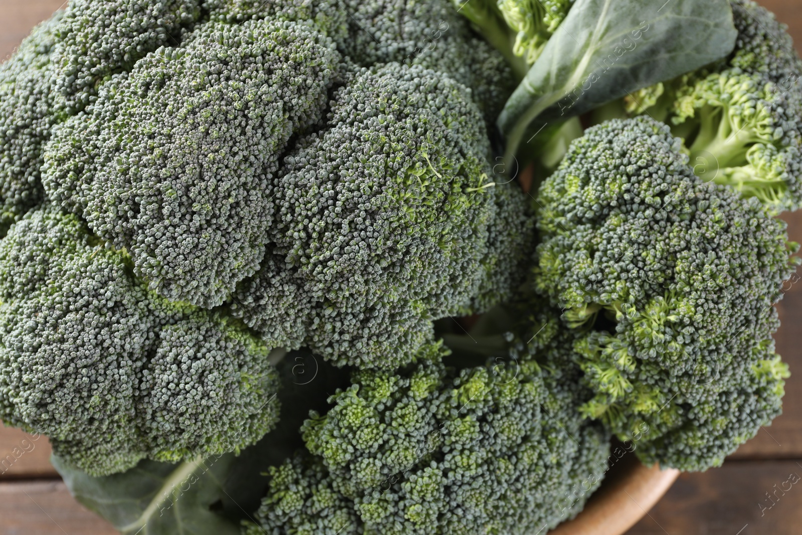 Photo of Fresh raw broccoli on table, above view