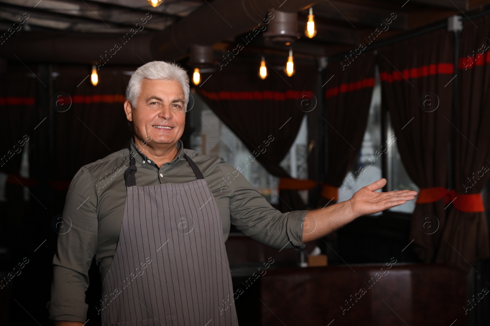 Photo of Senior male business owner in his restaurant