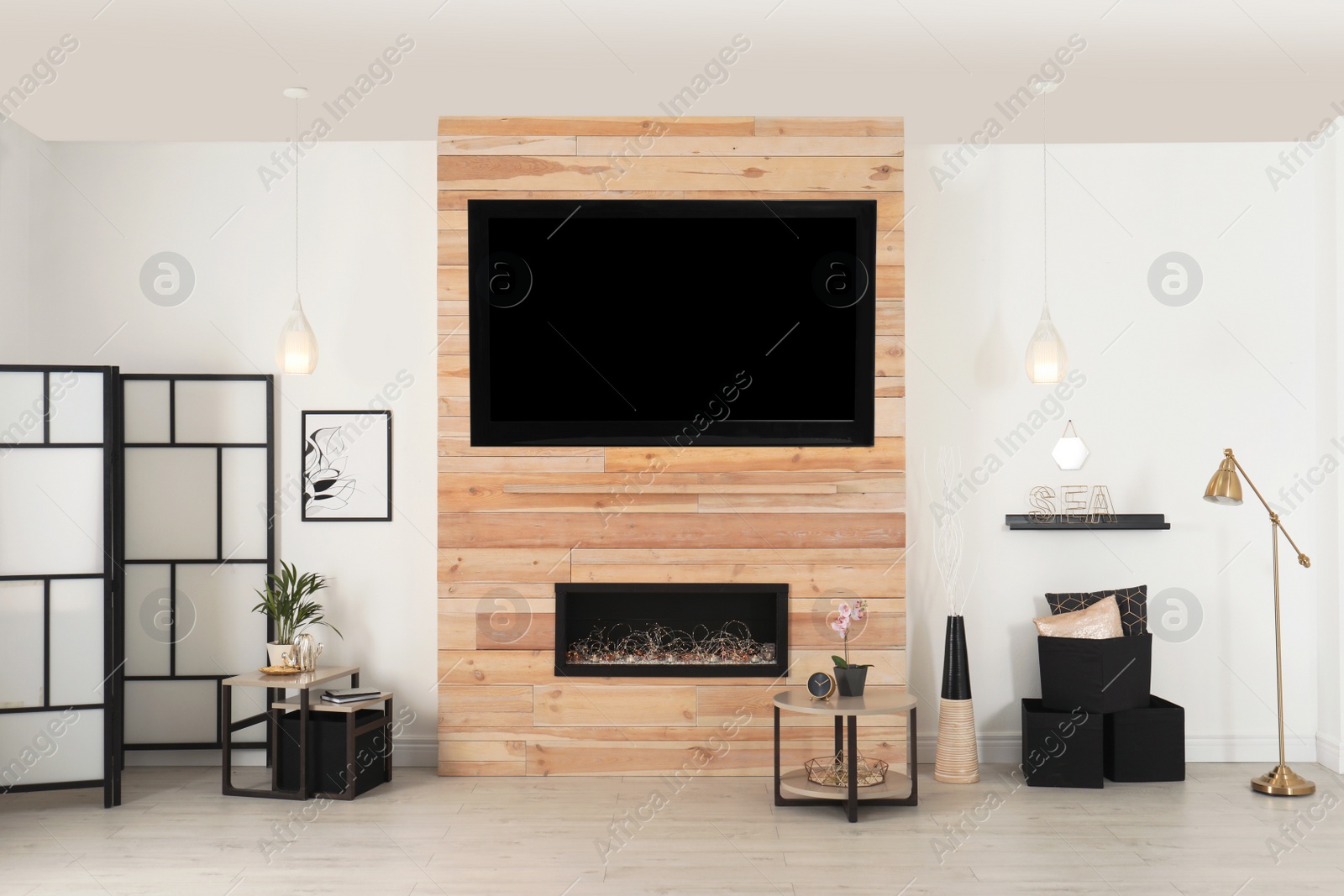 Photo of Living room interior with decorative fireplace in wooden wall