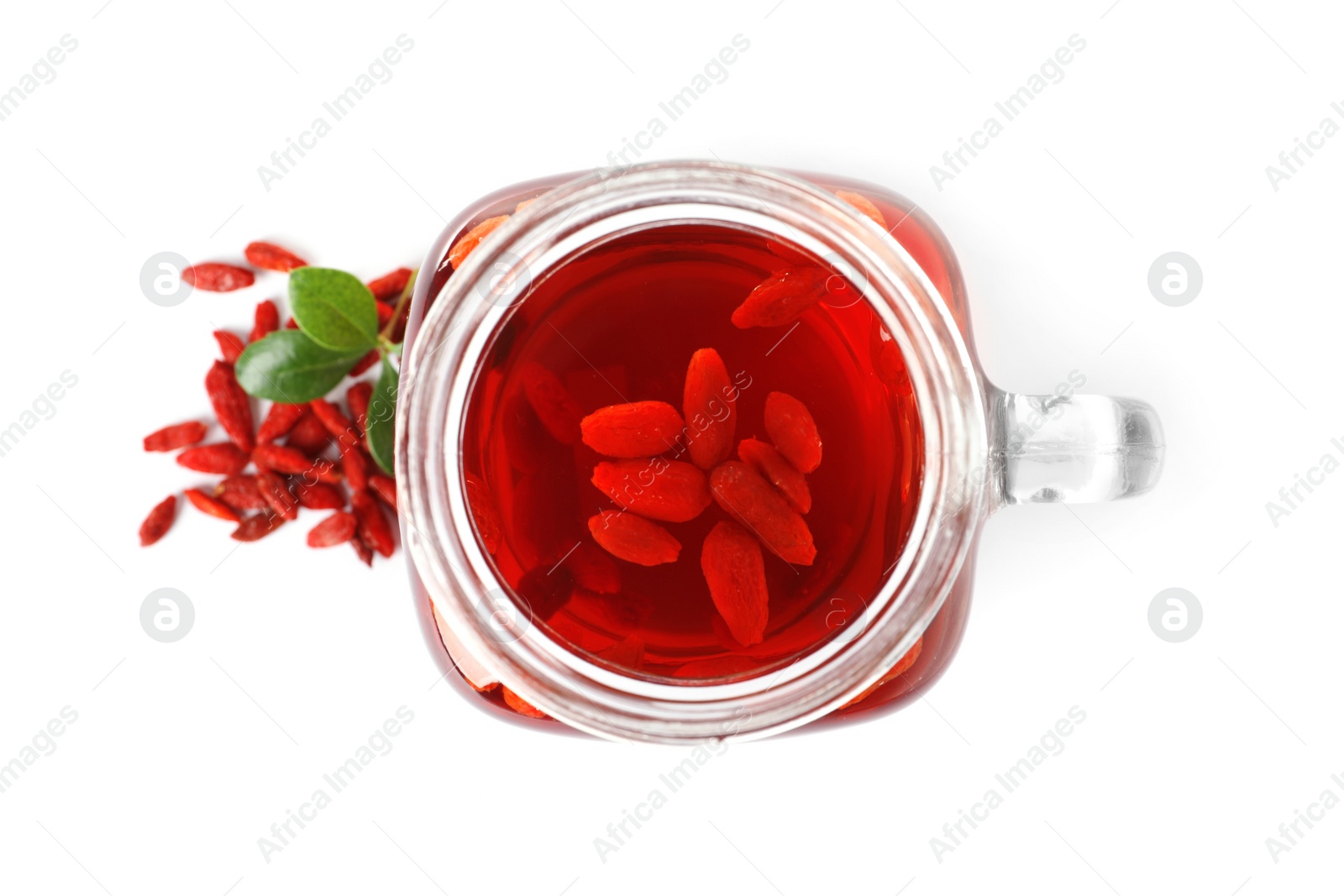 Photo of Healthy goji juice in mason jar with berries on white background, top view