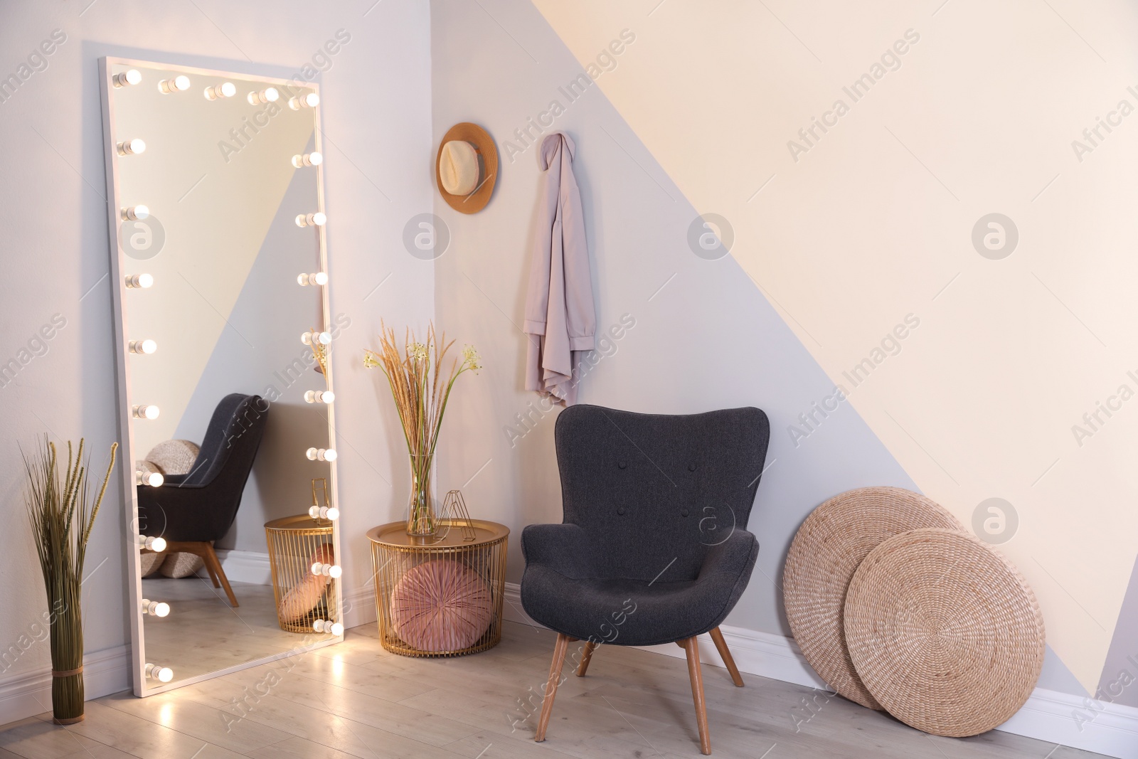 Photo of Large mirror with lamps in stylish room interior