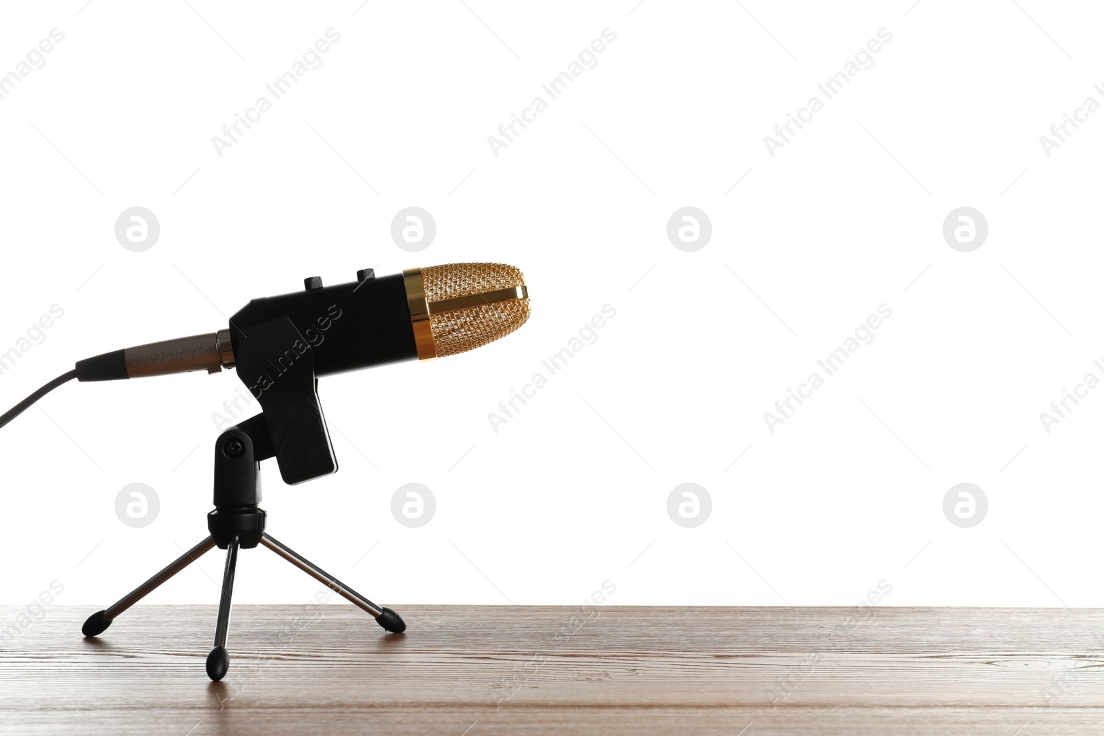 Photo of Microphone on table against white background. Space for text